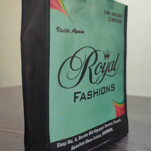 Box style loop handle bag with black side panels and green laminated full colour printing