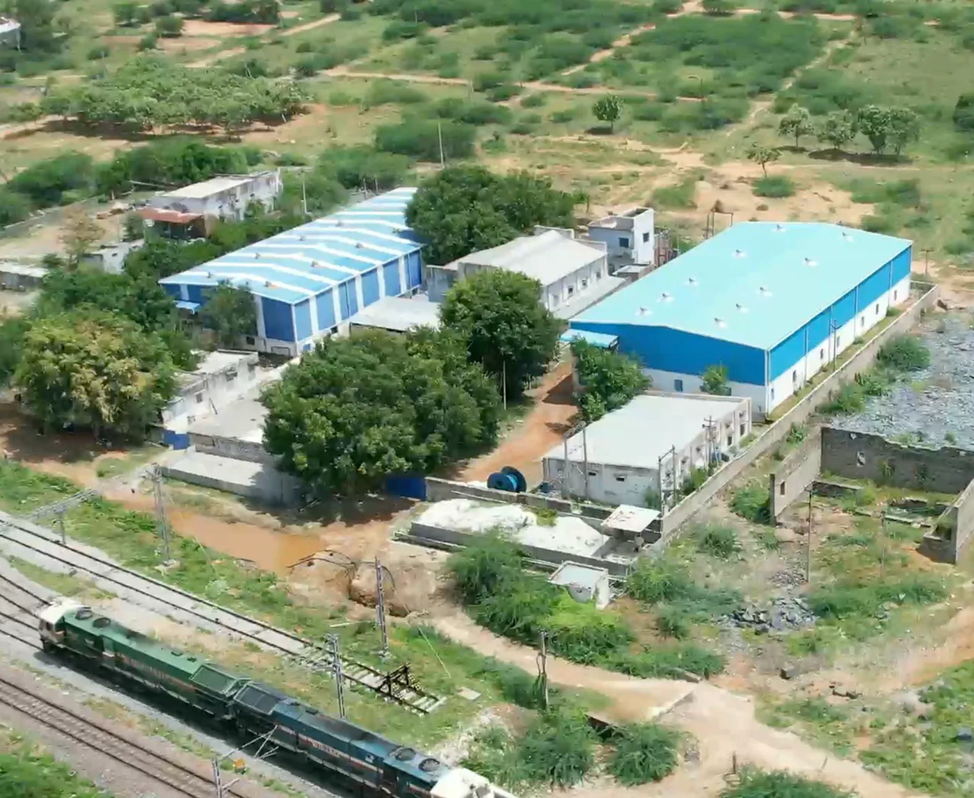 Aerial view of the Sri Raja Plastic Industries manufacturing unit at Dorapalli, Dhone, with the railway line running past the site