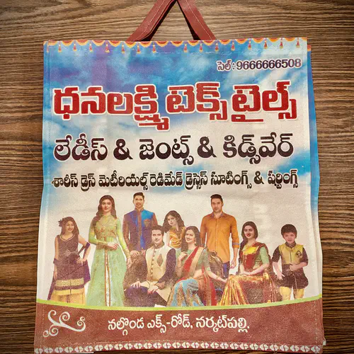 Loop handle non woven bag with full colour Telugu printing, made for a textile shop